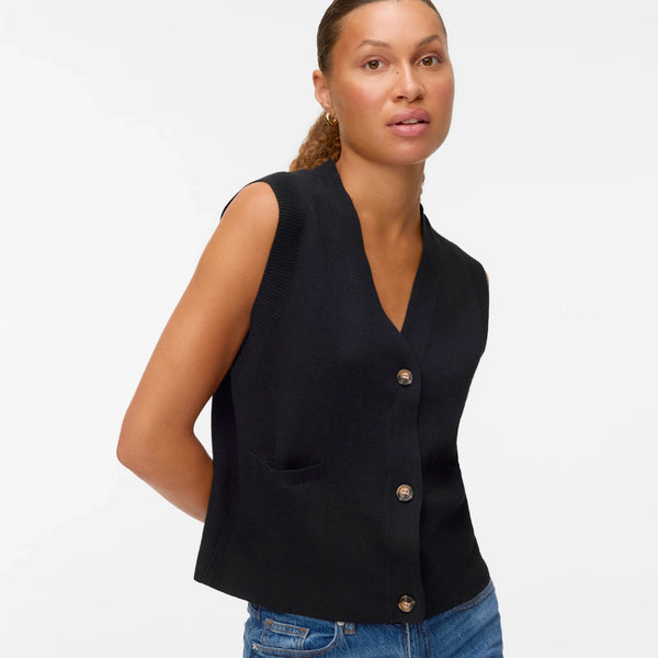 Women’s black sweater vest with button front, V-neckline, and patch pockets for chic layered and minimalist outfits.