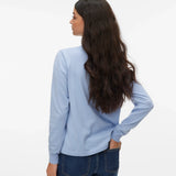 Light blue women's knit pullover with crew neck, ribbed cuffs and relaxed silhouette styled with dark wash jeans.