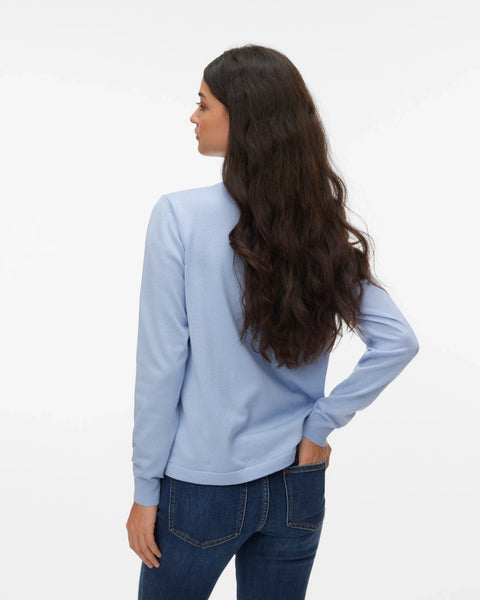 Light blue women's knit pullover with crew neck, ribbed cuffs and relaxed silhouette styled with dark wash jeans.