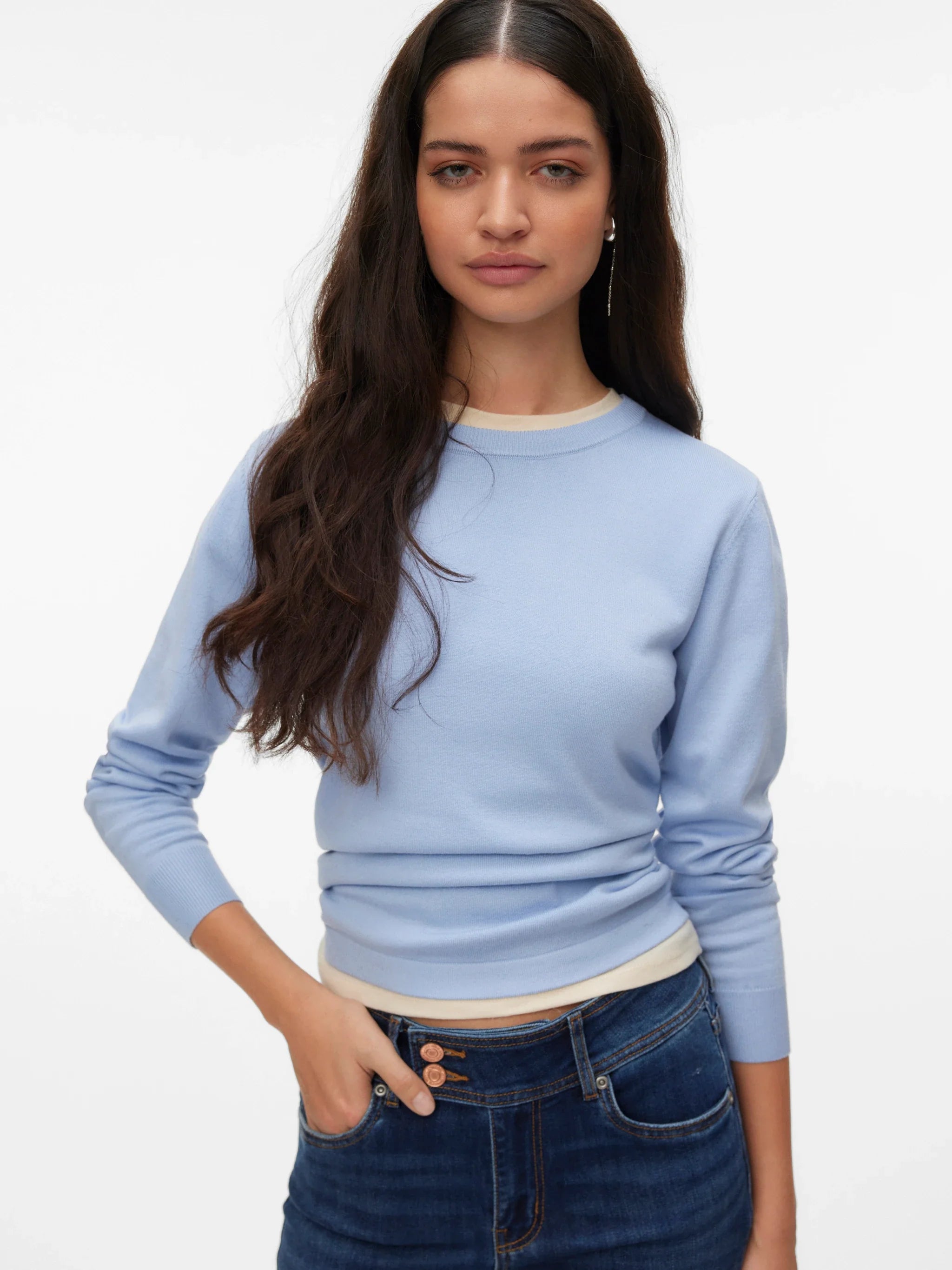 Women's minimalist light blue crew neck sweater with ribbed cuffs for versatile layering, travel and capsule wardrobe styling.