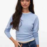 Women's minimalist light blue crew neck sweater with ribbed cuffs for versatile layering, travel and capsule wardrobe styling.