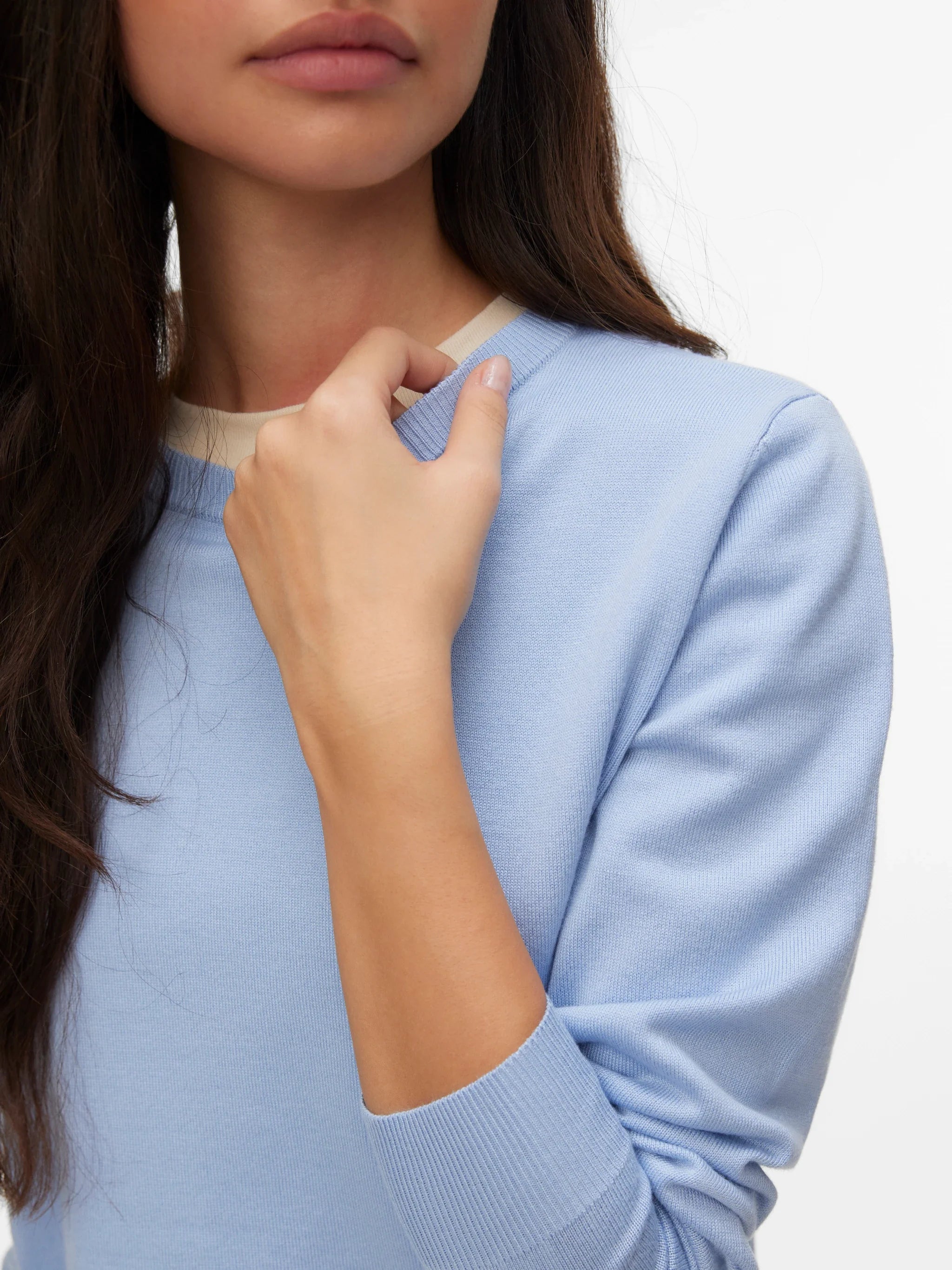 Women's classic powder blue lightweight knit pullover styled with dark denim for a timeless elevated casual everyday look.