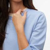 Women's classic powder blue lightweight knit pullover styled with dark denim for a timeless elevated casual everyday look.
