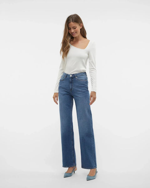 Trendy wide leg blue jeans featuring high-rise waist and effortless minimalist street-style aesthetic for women.