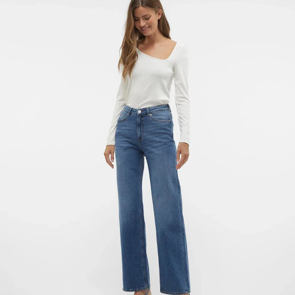 Trendy wide leg blue jeans featuring high-rise waist and effortless minimalist street-style aesthetic for women.