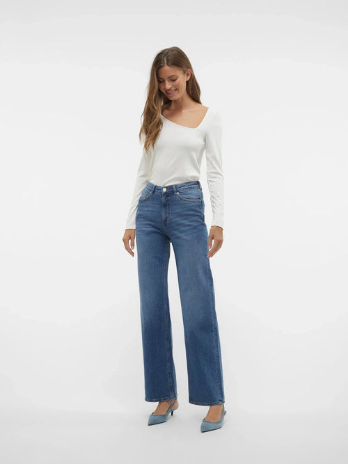 Trendy wide leg blue jeans featuring high-rise waist and effortless minimalist street-style aesthetic for women.