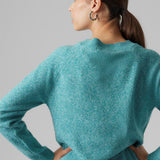 Relaxed-fit women’s teal knit jumper with cozy texture and understated modern fashion design.