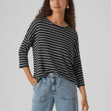 Contemporary striped long sleeve top in black and white with oversized silhouette and modern boutique style.