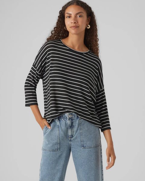 Contemporary striped long sleeve top in black and white with oversized silhouette and modern boutique style.