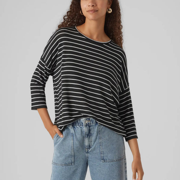 Contemporary striped long sleeve top in black and white with oversized silhouette and modern boutique style.
