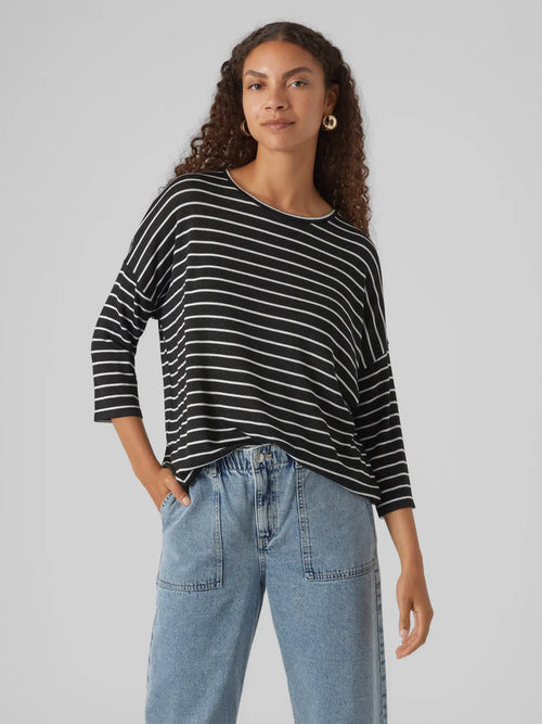 Contemporary striped long sleeve top in black and white with oversized silhouette and modern boutique style.