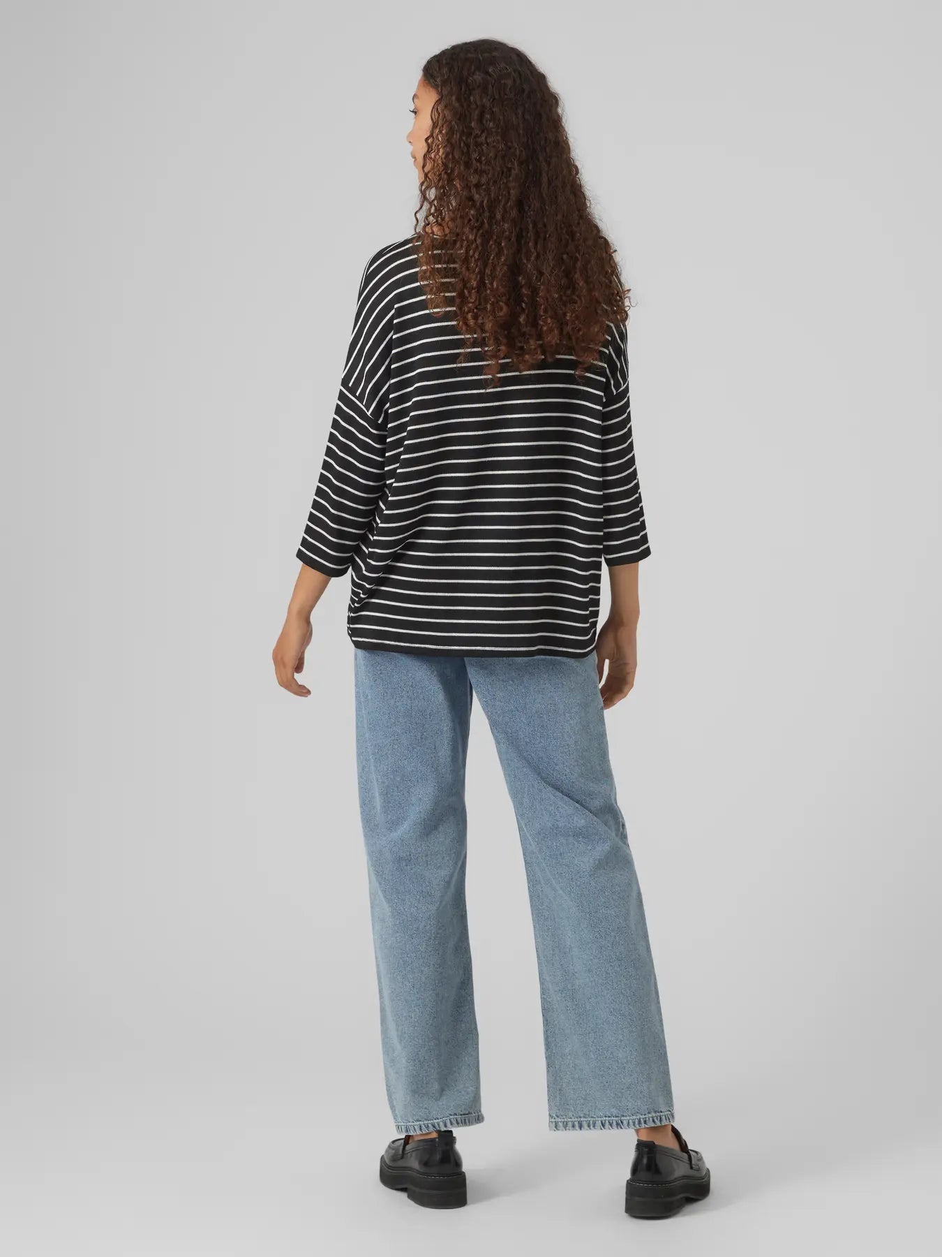 Women’s relaxed-fit striped knit top paired with denim for trendy casual weekend outfit inspiration.