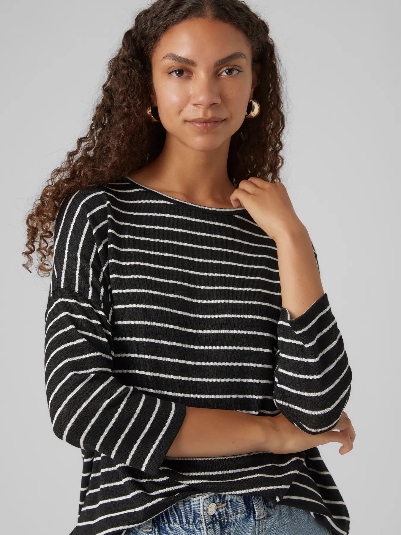 Resort cruise ship chic trendy black and white stripe knit top with effortless oversized fit and chic urban-inspired design.