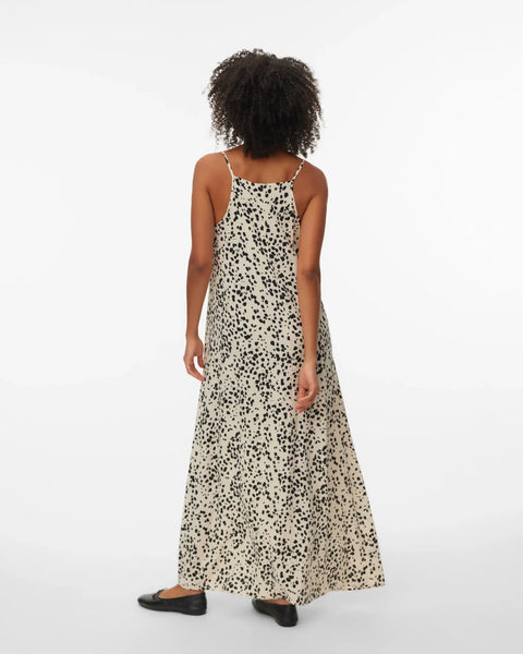 Women's lightweight black and cream spotted maxi dress featuring a flattering relaxed silhouette and effortless resort-inspired style.